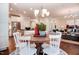 Open-concept dining area with chandelier, white chairs, and seamless access to the living room and kitchen at 150 Green Haven Blvd # 67, Youngsville, NC 27596