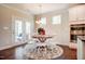 Sunlit dining area features a round table, white chairs, and direct access to the outdoor patio at 150 Green Haven Blvd # 67, Youngsville, NC 27596