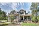 Charming two-story home featuring stone accents, gray siding, well-manicured lawn, and mature trees at 150 Green Haven Blvd # 67, Youngsville, NC 27596
