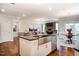 Modern kitchen island features white cabinetry, stainless steel sink and overlooks the living room at 150 Green Haven Blvd # 67, Youngsville, NC 27596