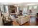 Open concept living room with stone fireplace, hardwood floors, and dining area at 150 Green Haven Blvd # 67, Youngsville, NC 27596