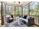Relaxing screened-in porch with comfortable seating and views of the lush surroundings at 150 Green Haven Blvd # 67, Youngsville, NC 27596