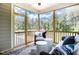 Relaxing screened-in porch with comfortable seating and views of the lush surroundings at 150 Green Haven Blvd # 67, Youngsville, NC 27596