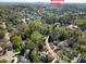 Scenic aerial view highlighting the home's location within a tree-filled neighborhood near downtown Raleigh at 1925 Banbury Rd, Raleigh, NC 27608