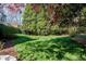 Expansive backyard with lush green lawn and mature landscaping at 1925 Banbury Rd, Raleigh, NC 27608