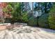 Spacious backyard with a brick patio and a basketball court surrounded by trees at 1925 Banbury Rd, Raleigh, NC 27608