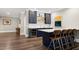 This entertainment bar features seating, a wine fridge and custom cabinetry at 1925 Banbury Rd, Raleigh, NC 27608
