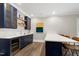 This bar features custom cabinetry, a wine fridge, and quartz countertops at 1925 Banbury Rd, Raleigh, NC 27608