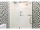 Modern shower with black and white tile and geometric patterned walls at 1925 Banbury Rd, Raleigh, NC 27608