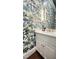 Chic bathroom features a patterned wallpaper, white cabinets, and custom fixtures at 1925 Banbury Rd, Raleigh, NC 27608
