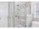 Bright bathroom features a glass shower, marble tile, and built in bench at 1925 Banbury Rd, Raleigh, NC 27608