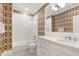 Stylish bathroom with white subway tile shower, black and white mosaic floor, and patterned wallpaper at 1925 Banbury Rd, Raleigh, NC 27608