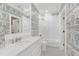 Elegant bathroom with white subway tile shower, black and white mosaic floor, and patterned wallpaper at 1925 Banbury Rd, Raleigh, NC 27608