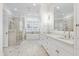 Elegant primary bathroom featuring marble floors, double vanity, soaking tub, and glass shower at 1925 Banbury Rd, Raleigh, NC 27608
