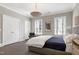 Bedroom features a pendant light, two windows, and an accent chair at 1925 Banbury Rd, Raleigh, NC 27608