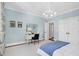 Bedroom with light blue walls, a chandelier, and bright white trim at 1925 Banbury Rd, Raleigh, NC 27608