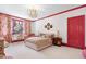 Cozy bedroom features pink trim, a comfortable bed, and a charming window seat at 1925 Banbury Rd, Raleigh, NC 27608