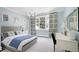Light-filled bedroom with light blue walls, patterned curtains, and a desk at 1925 Banbury Rd, Raleigh, NC 27608