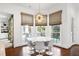 Inviting breakfast nook with bay window, statement lighting and table for six at 1925 Banbury Rd, Raleigh, NC 27608