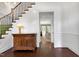 Elegant foyer with hardwood floors, staircase with green runner, and view into the living room at 1925 Banbury Rd, Raleigh, NC 27608