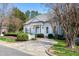 Charming white home with a meticulously landscaped front yard and a paved walkway leading to the entrance at 1925 Banbury Rd, Raleigh, NC 27608
