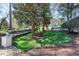 Lush front yard with manicured lawn, trees, and a white brick retaining wall at 1925 Banbury Rd, Raleigh, NC 27608