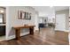 Welcoming hallway showcasing wood floors, modern art, and access to other rooms at 1925 Banbury Rd, Raleigh, NC 27608