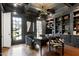 Sophisticated home office with built-in shelving, hardwood floors, and natural light from multiple windows at 1925 Banbury Rd, Raleigh, NC 27608