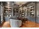 Luxurious home office features extensive built-in shelving, coffered ceiling, and elegant decor at 1925 Banbury Rd, Raleigh, NC 27608