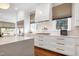 Updated gourmet kitchen showcasing white cabinetry, marble countertops, stainless steel appliances, and hardwood floors at 1925 Banbury Rd, Raleigh, NC 27608