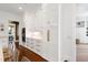 Bright kitchen featuring custom white cabinetry, gold hardware, and modern built-in stainless steel appliances at 1925 Banbury Rd, Raleigh, NC 27608