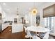 Open concept kitchen and breakfast nook featuring white cabinetry, a center island, and stainless steel appliances at 1925 Banbury Rd, Raleigh, NC 27608