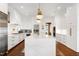 Gourmet kitchen boasting white cabinetry, an expansive island, stainless steel appliances, and modern fixtures at 1925 Banbury Rd, Raleigh, NC 27608
