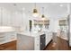 Open kitchen with center island, stainless steel appliances, abundant cabinets, and adjacent breakfast nook at 1925 Banbury Rd, Raleigh, NC 27608