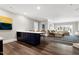 Open-concept living room features a bar area, recessed lighting, and hardwood floors at 1925 Banbury Rd, Raleigh, NC 27608