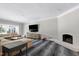 Living room features a fireplace, a large sectional sofa, and hardwood floors at 1925 Banbury Rd, Raleigh, NC 27608