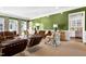 Spacious living room boasting olive green walls, white trim, an array of seating and a mini-bar area at 1925 Banbury Rd, Raleigh, NC 27608