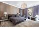 Spacious main bedroom with plush carpeting, decorative lighting, and designer window treatments at 1925 Banbury Rd, Raleigh, NC 27608