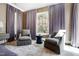 Bright main bedroom featuring comfortable seating, neutral decor, and natural light at 1925 Banbury Rd, Raleigh, NC 27608