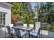 Outdoor patio with a table and chairs, surrounded by lush greenery and a serene atmosphere at 1925 Banbury Rd, Raleigh, NC 27608