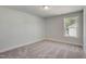 Bright, neutral bedroom with plush carpet and ample natural light from the large window at 195 Duncan Creek Rd # 123, Lillington, NC 27546