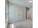 Neutral bedroom featuring plush carpet, a closet, and doorway showcasing the home's layout at 195 Duncan Creek Rd # 123, Lillington, NC 27546