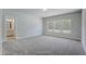 Bright bedroom features neutral walls, carpet, and an abundance of natural light from three large windows at 195 Duncan Creek Rd # 123, Lillington, NC 27546