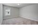 Neutral bedroom boasts a window with view to the home's exterior at 195 Duncan Creek Rd # 123, Lillington, NC 27546