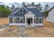 Beautiful one-story home showcasing detailed trim and a covered entryway under construction at 195 Duncan Creek Rd # 123, Lillington, NC 27546