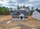 New construction, single-story home with gray siding, set on a large lot at 195 Duncan Creek Rd # 123, Lillington, NC 27546