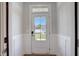 Bright entryway features wainscoting and a clear view of the front yard through a glass door at 195 Duncan Creek Rd # 123, Lillington, NC 27546