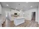 Well-lit kitchen featuring white cabinetry, quartz countertops, and stainless steel appliances at 195 Duncan Creek Rd # 123, Lillington, NC 27546