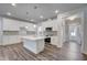 Modern kitchen featuring an island, white cabinets, and stainless steel appliances for an open concept feel at 195 Duncan Creek Rd # 123, Lillington, NC 27546