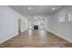 Spacious living room with wood-look floors, a fireplace, and abundant natural light at 195 Duncan Creek Rd # 123, Lillington, NC 27546